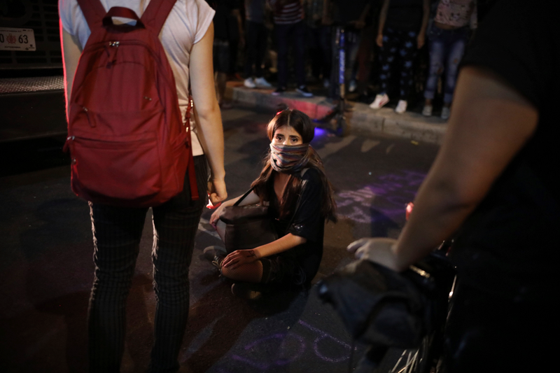A protester blocks a fire truck from gaining access to the police station